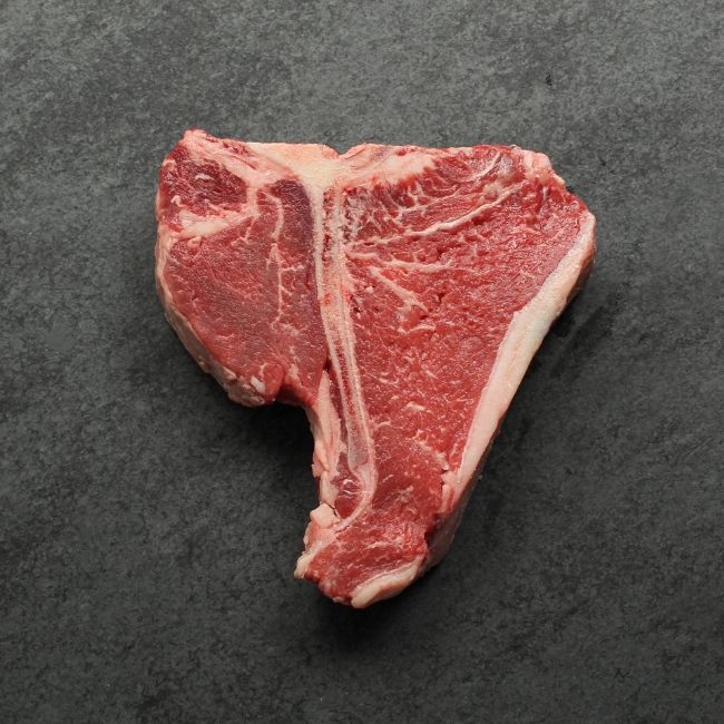 overhead image of the underside of a raw T-bone steak