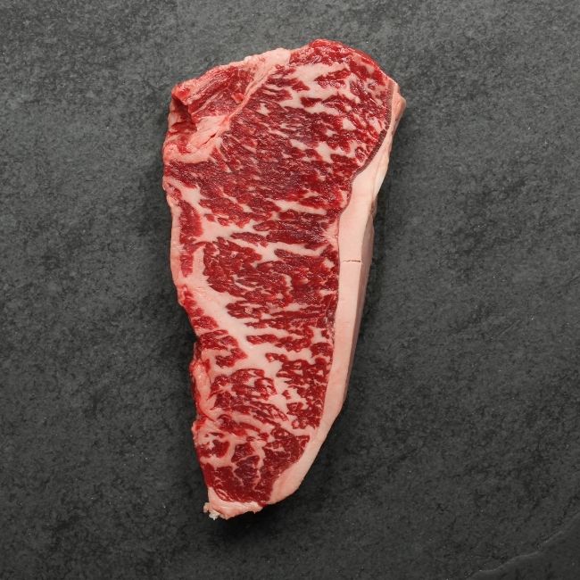 overhead image of the underside of a heavily marbled Australian wagyu new york steak