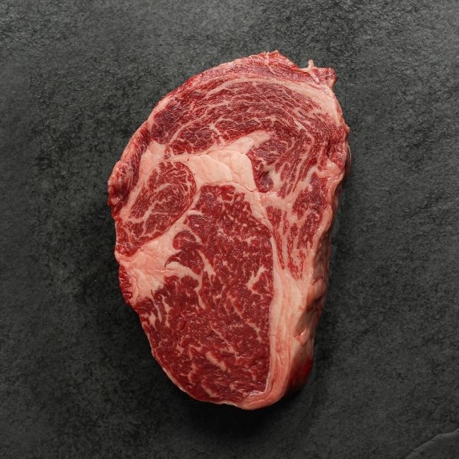 overhead view of the underside of a heavily marbled Australian wagyu rib eye steak