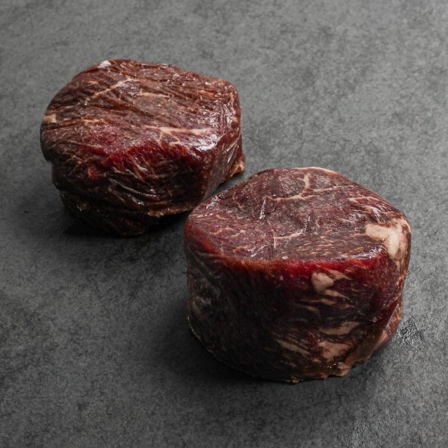 angled view of two raw Australian wagyu beef sirloin steaks