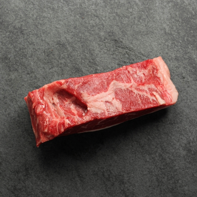 Side view of a raw New York steak.