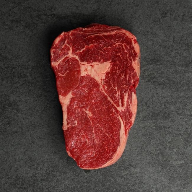 overhead image of a raw grass fed rib eye steak