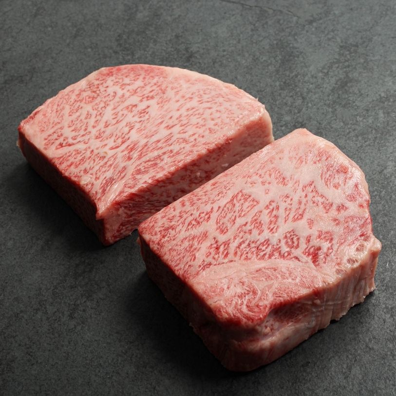 overhead view of two raw Japanese A5 wagyu New York Steaks - California cut