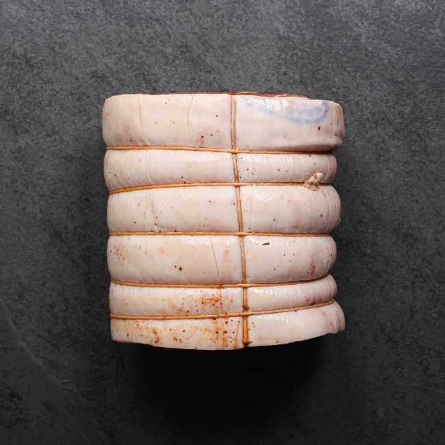overhead view of a raw, seasoned and tied porchetta roast