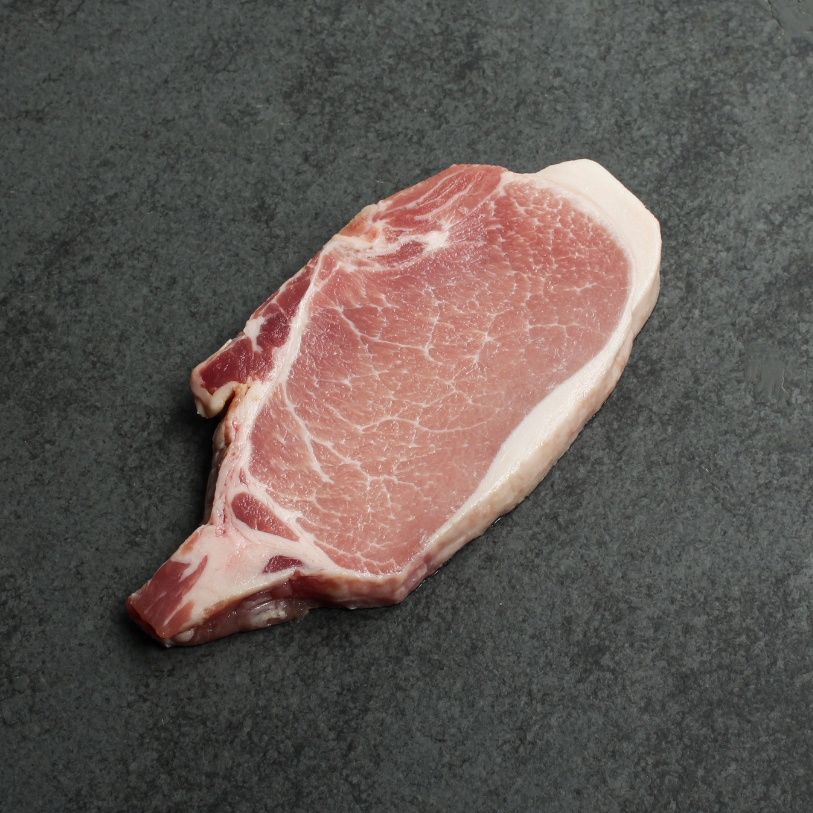 Overhead image of uncooked bone-in pork chop sourced in Canada.