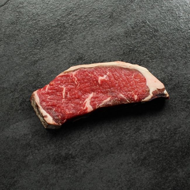 Bottom side of dry aged New York steak.