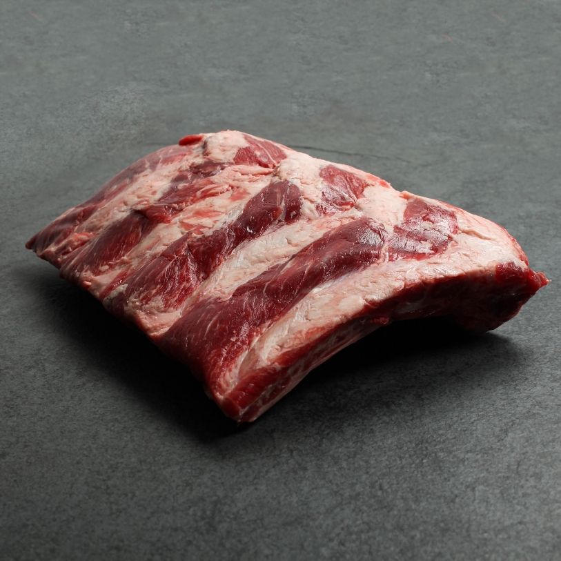 overhead view of a halved rack of raw beef back ribs