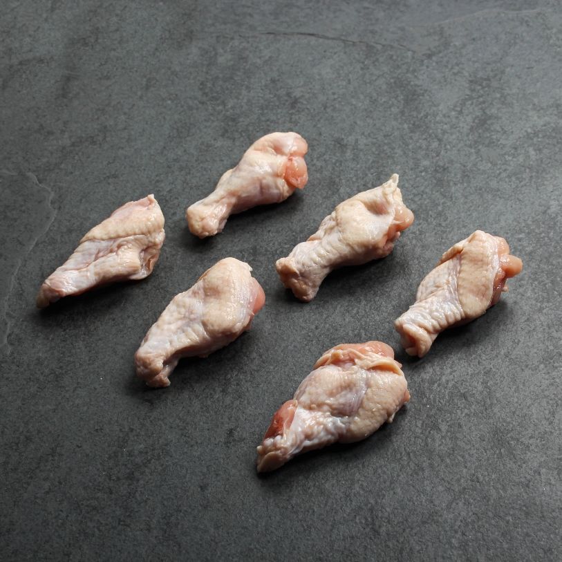 angled view of 6 raw chicken wing fryer drumette