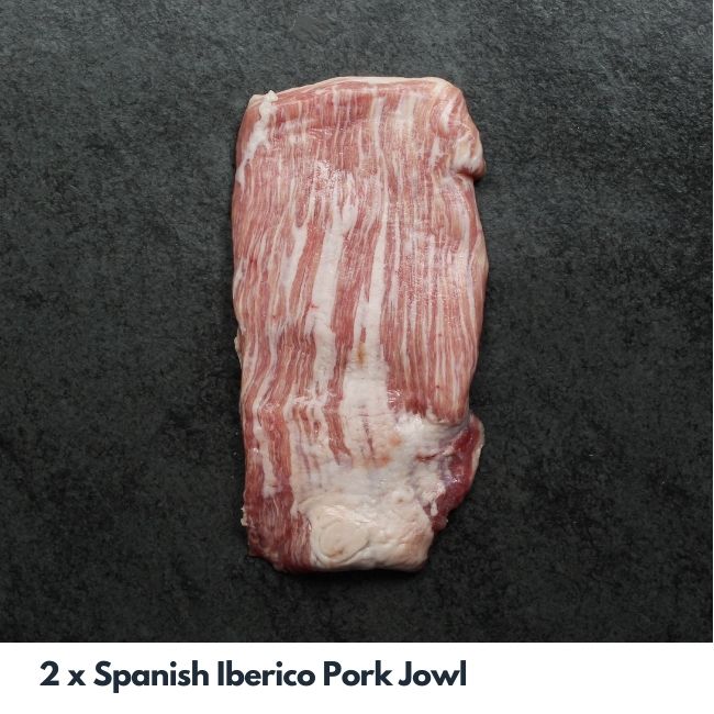 overhead image of a heavily-marbled, raw cut of Spanish Iberico pork jowl