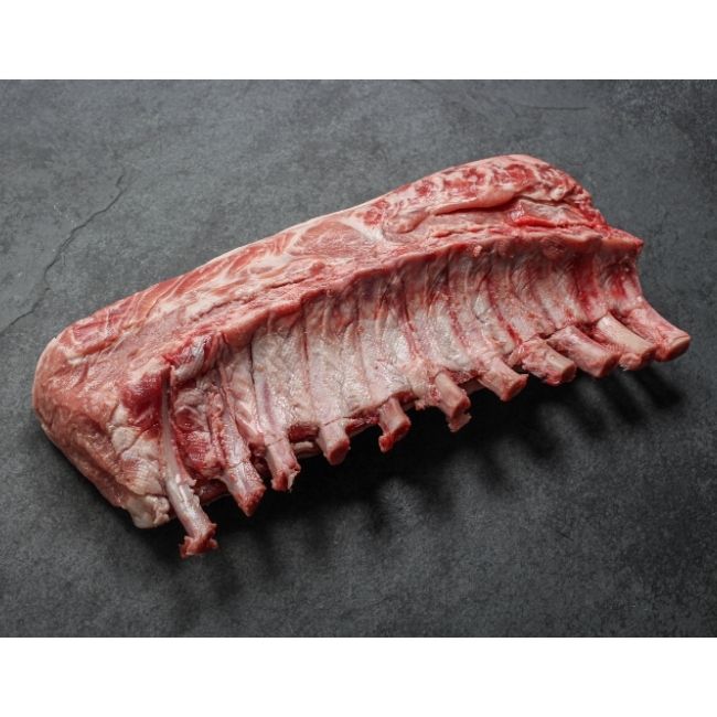 angled view of a Spanish Iberico pork rack with frenched bones