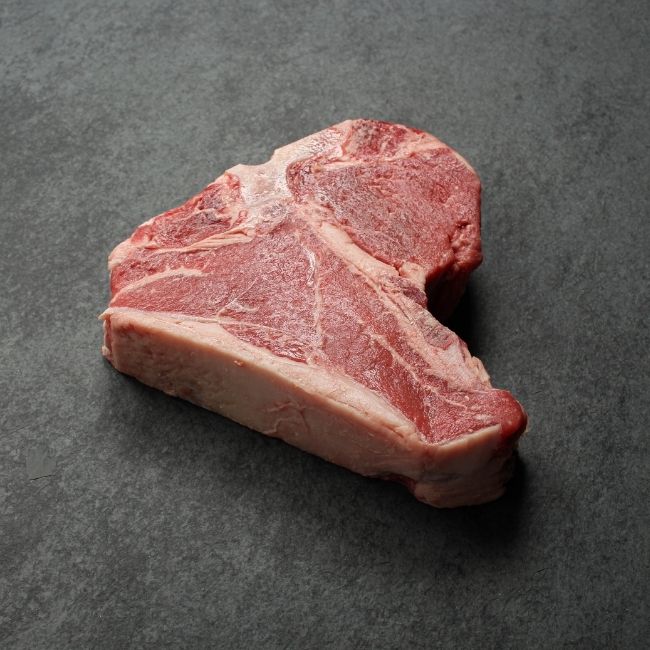 angled view of a raw T-bone steak