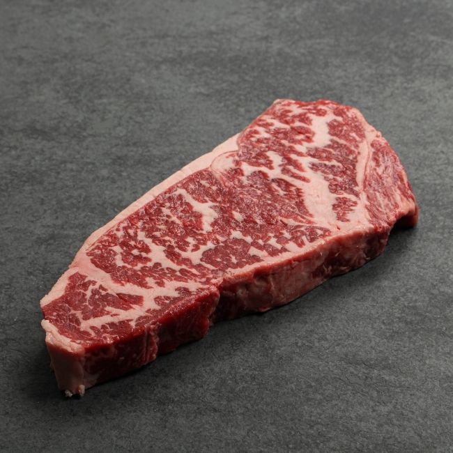 angled view of a heavily marbled Australian wagyu new york steak