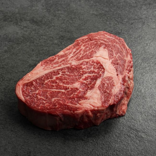 angled view of a heavily marbled Australian wagyu rib eye steak