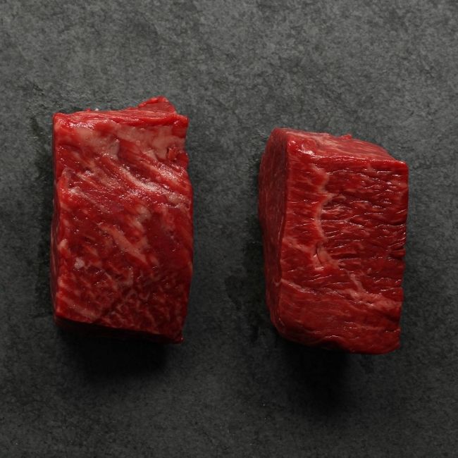 overhead view of the sides of two well-marbled sirloin steaks