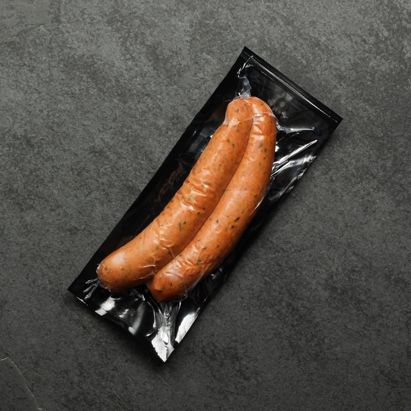 Overhead view of two Chicken & Turkey Sausages in vacuum packaging..