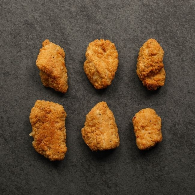 overhead view of cooked, golden-brown crispy breaded chicken bites