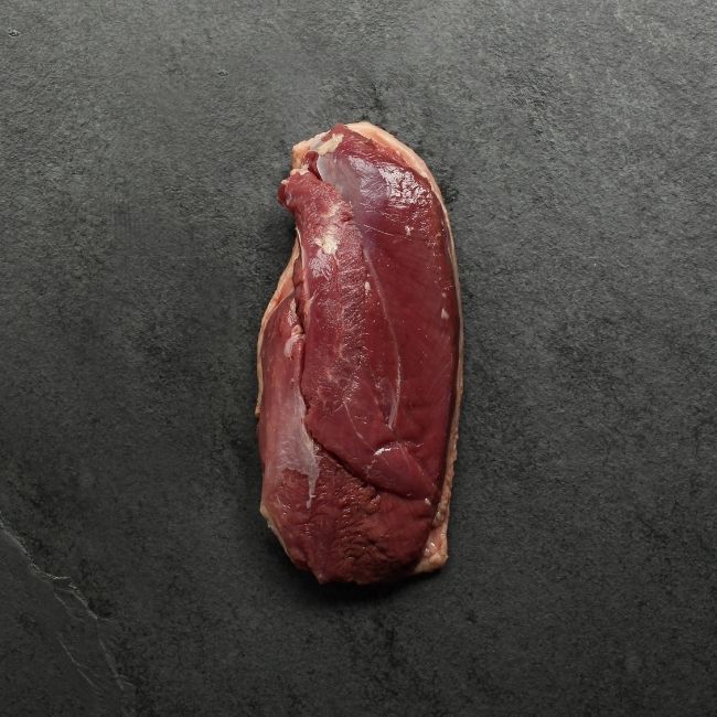 overhead view of the flesh side of a piece of raw duck magret