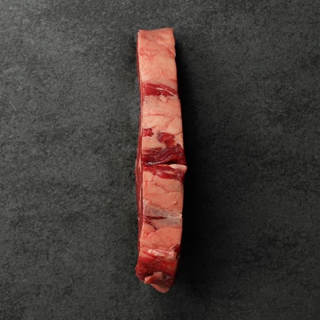 overhead image of the side of a raw grass fed rib eye steak