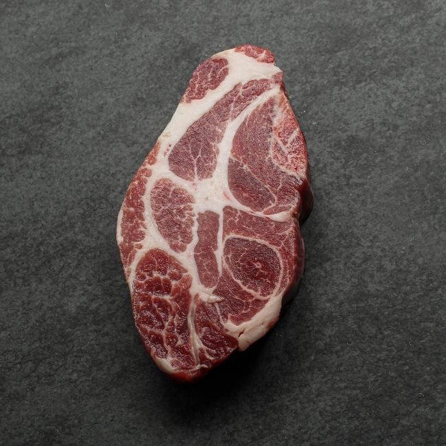 angled view of heavily marbled iberico pork collar steak