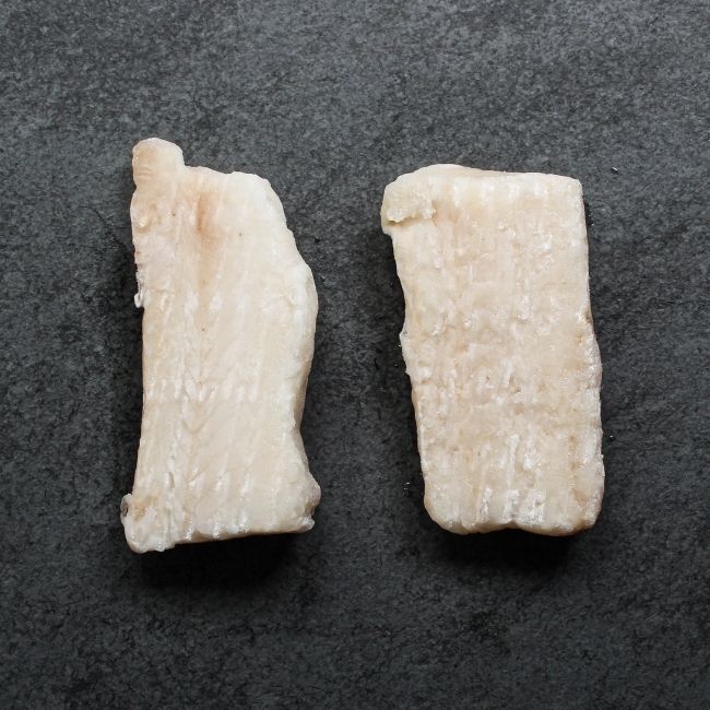 overhead view of two pieces of raw haddock filets