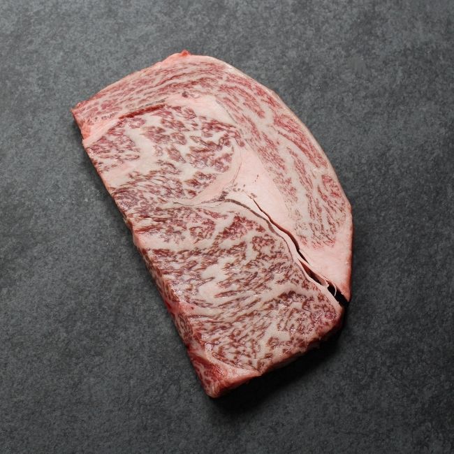 Overhead view of a heavily marbled wagyu rib eye steak.
