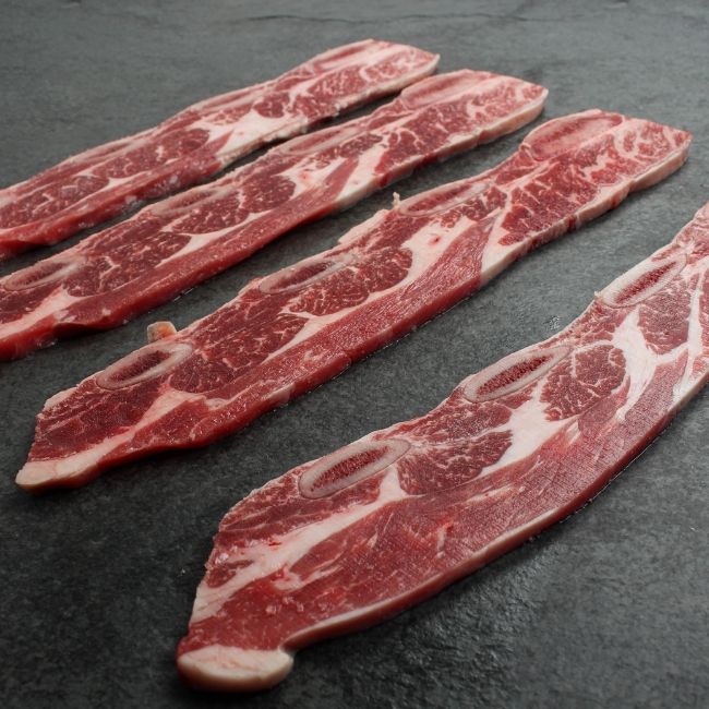 Side view of raw sliced chuck short ribs.