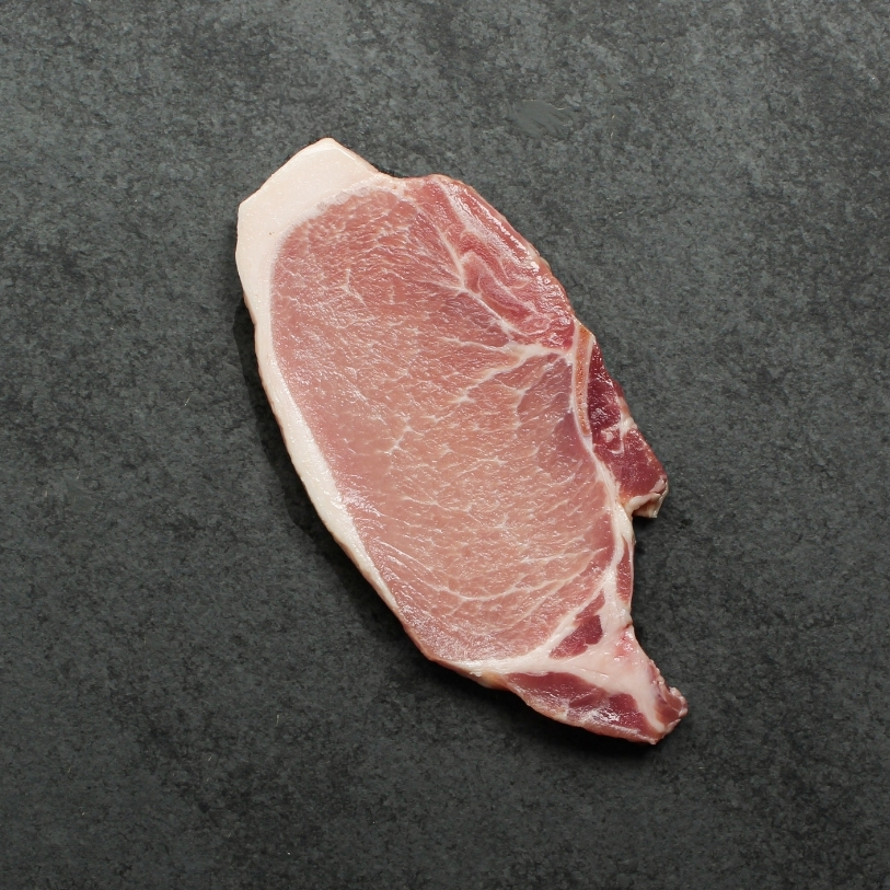 Overhead image of uncooked bone-in pork chop sourced in Canada.