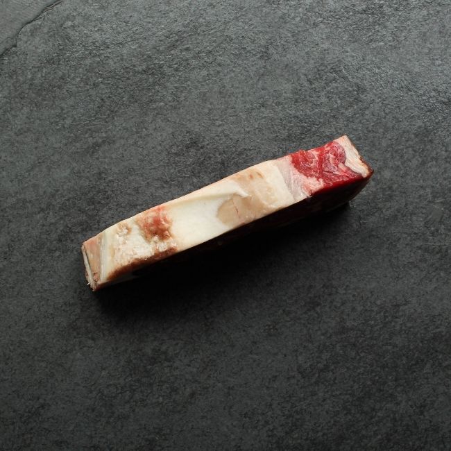 Side view of dry aged New York steak fat cap.