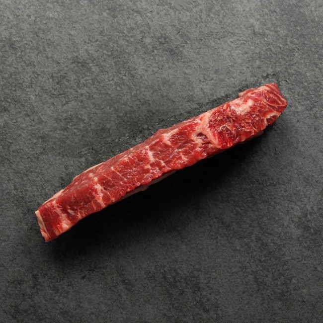Side view of a raw New York steak.