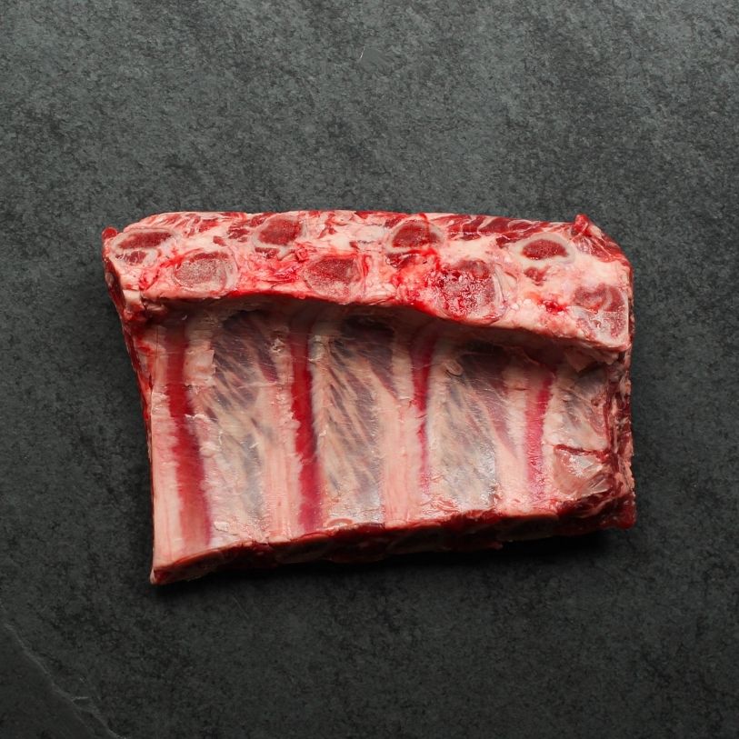 overhead view of a halved rack of raw beef back ribs