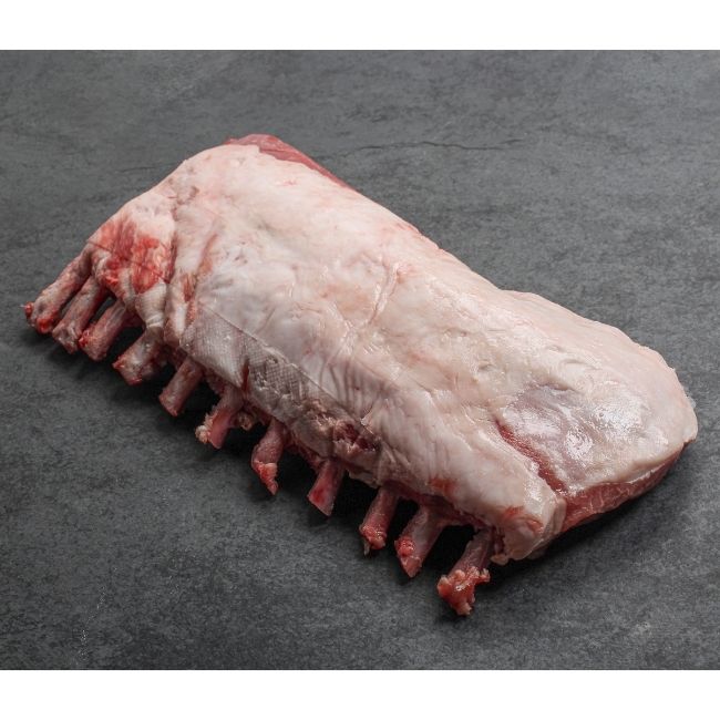 angled view of the fatty side of a Spanish Iberico pork rack with frenched bones