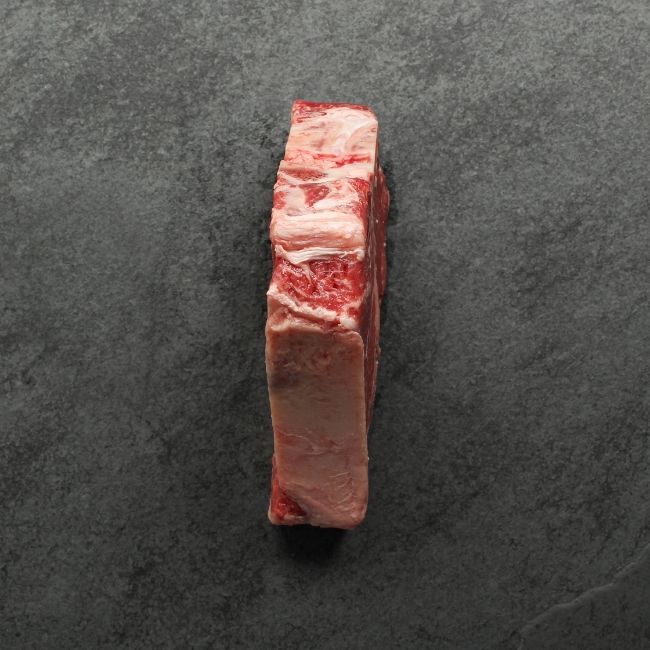 the side of a raw T-bone steak