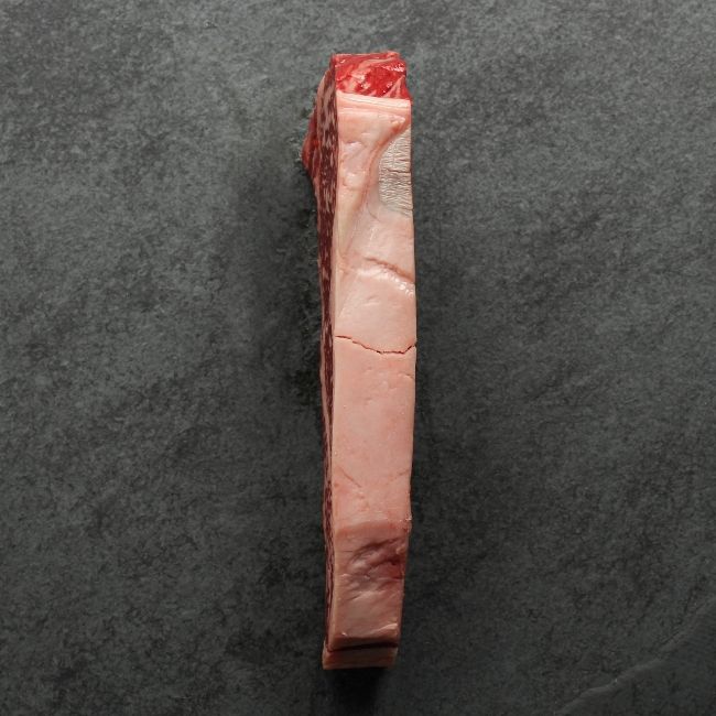 the fatty side of a heavily marbled Australian wagyu new york steak