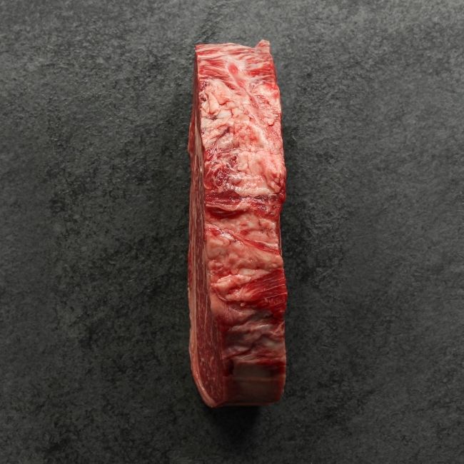 overhead view of the side of a heavily marbled Australian wagyu rib eye steak