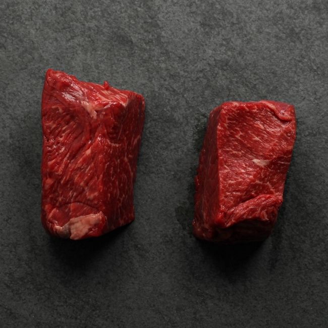 overhead view of the sides of two well-marbled sirloin steaks