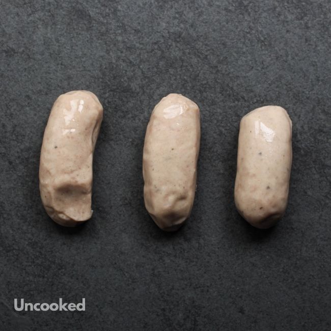 overhead view of 3 uncooked classic English breakfast banger sausages