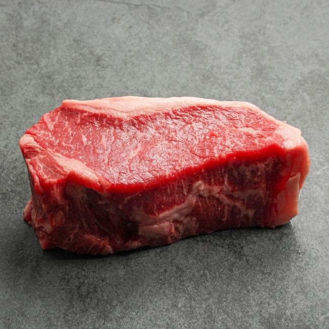 Angled view of a raw New York steak.