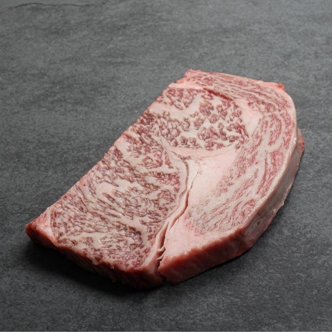 Side view of a heavily marbled wagyu rib eye steak.
