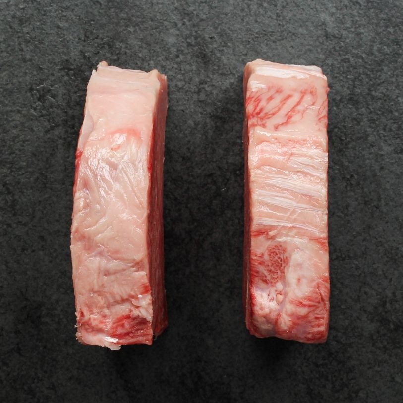 overhead view of the side of two raw Japanese A5 wagyu New York Steaks - California cut