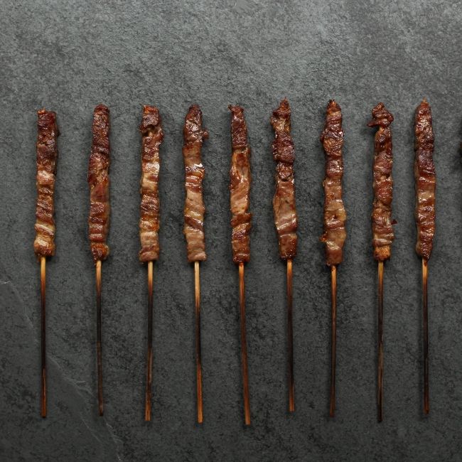 overhead view of cooked and browned mini lamb skewers