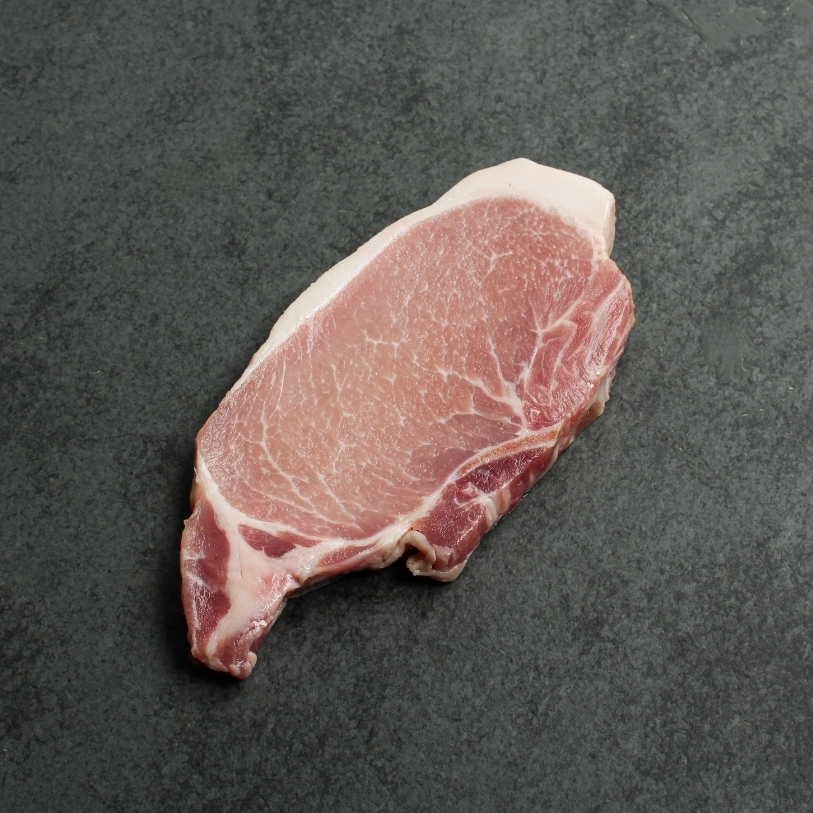 Overhead image of uncooked bone-in pork chop sourced in Canada.