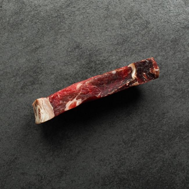 Side view of dry aged New York steak.