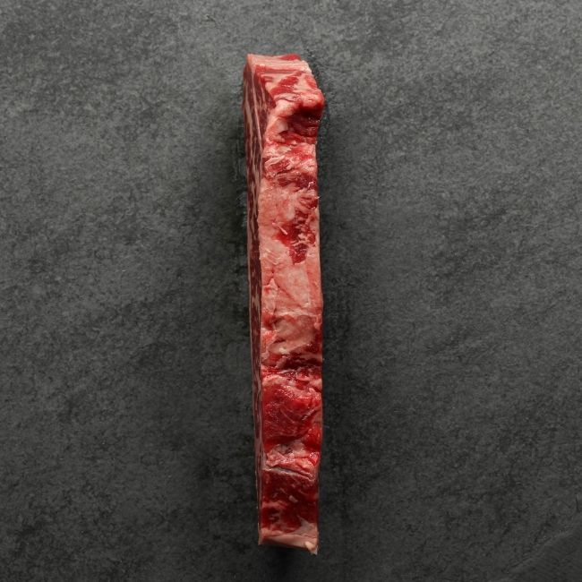 the side of a heavily marbled Australian wagyu new york steak