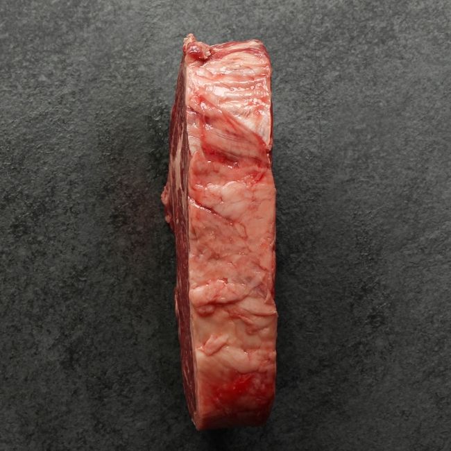 overhead view of the fatty side of a heavily marbled Australian wagyu rib eye steak