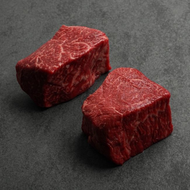 angled view of two well-marbled sirloin steaks