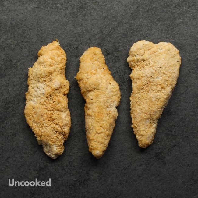 overhead view of uncooked crispy chicken fingers