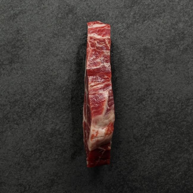 side view of heavily marbled iberico pork collar steak