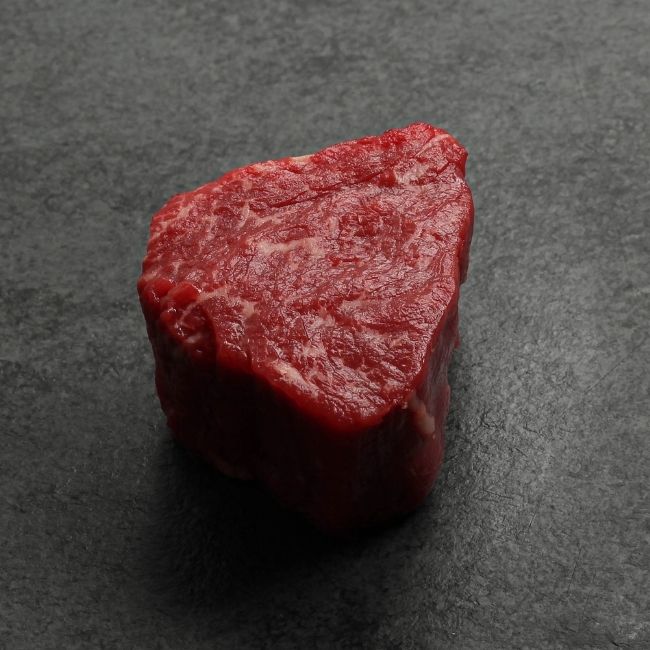 angled view of a raw American-Wagyu Hybrid 4 oz filet mignon