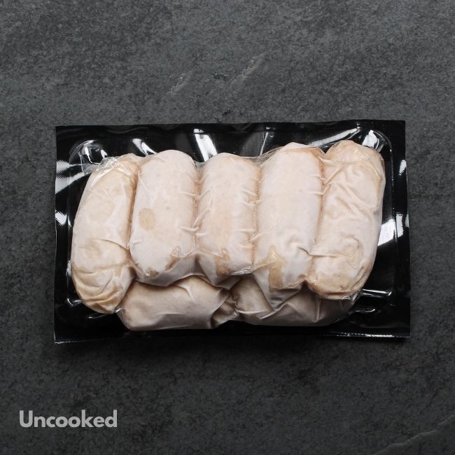 overhead view of 3 uncooked classic English breakfast banger sausages in a vacuum package