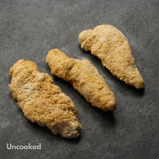 angled view of uncooked crispy chicken fingers